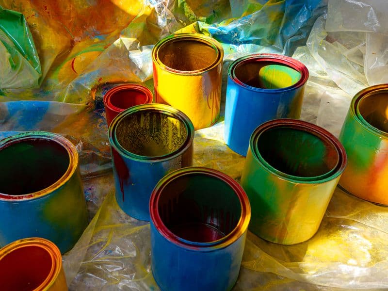 Open cans of colourful paint